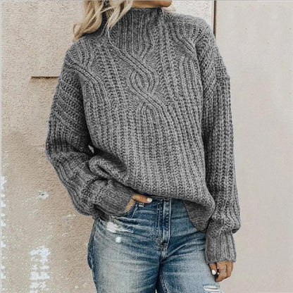 Grobstrickpullover mit Zopfmuster und Stehkragen in Grau, zu Jeans mit Rissen getragen